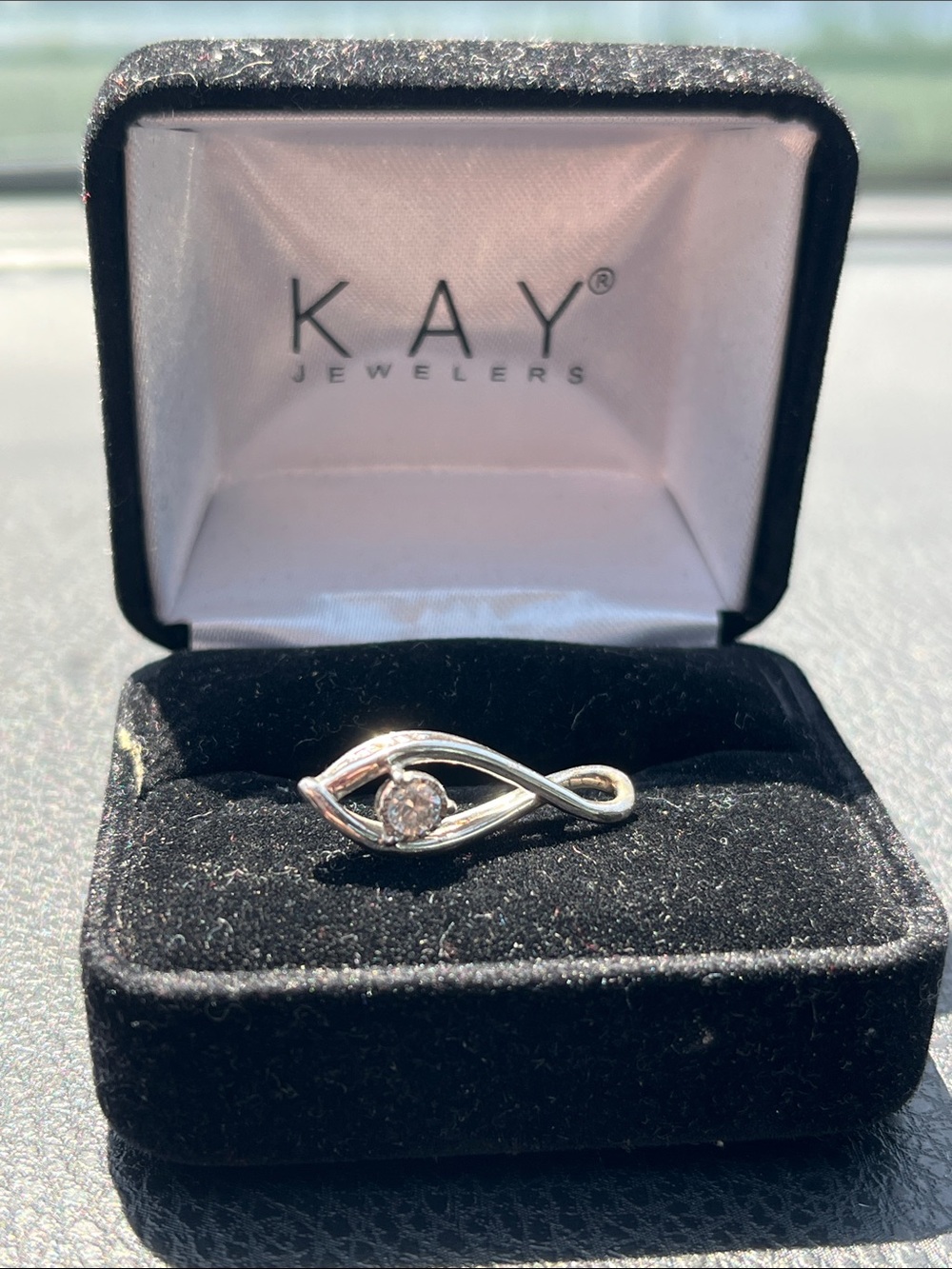 Kay Jewelers Silver Infinity Twist pendant  with center diamond